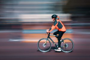 practice creative photography techniques like panning a cyclist on a course in London