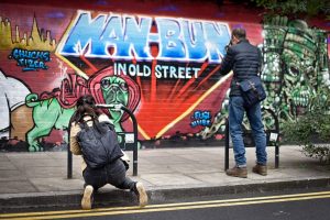 students on the London street photography course in central London taking pictures of graffiti art